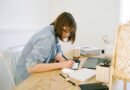 woman writing on a notebook