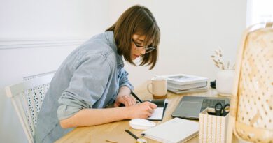 woman writing on a notebook