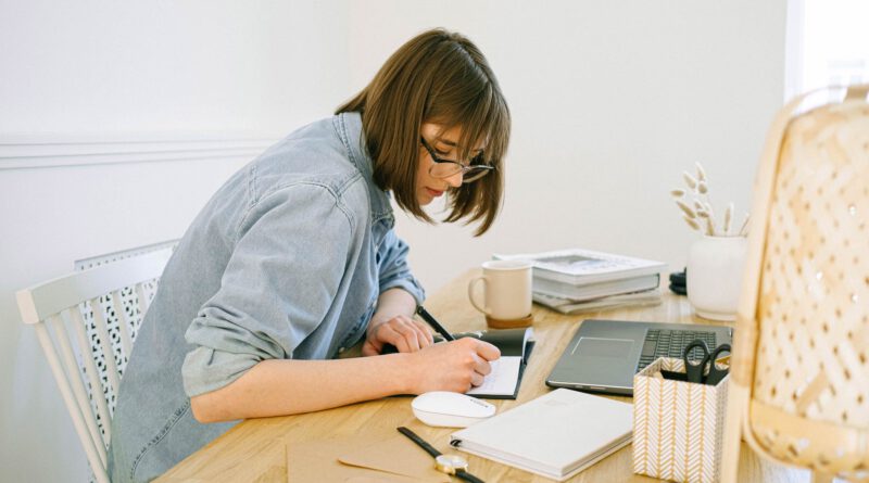 woman writing on a notebook